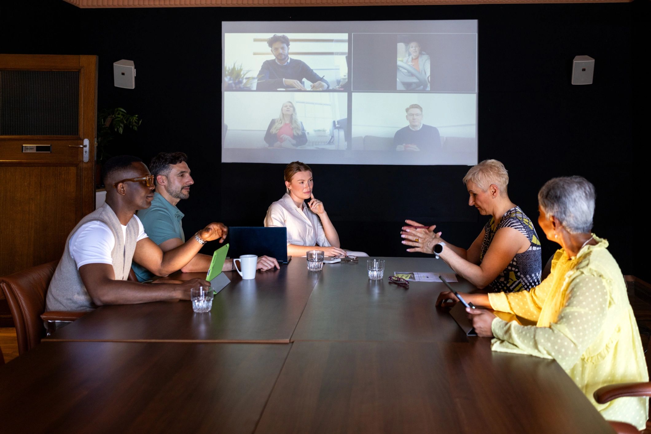 Hybrid conference team collaborating across in-person and remote participants